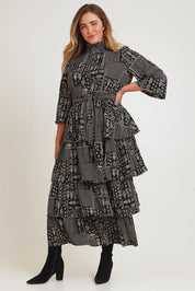 Model Chanel wearing size 16 of the Wonderland Tiered Dress in colour Blackwhite (Black), from the front, showing the whole outfit