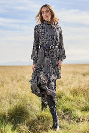 Model Tegan wearing size 10 of the Wonderland Tiered Dress in colour Blackwhite (Black), from the front, showing the whole outfit