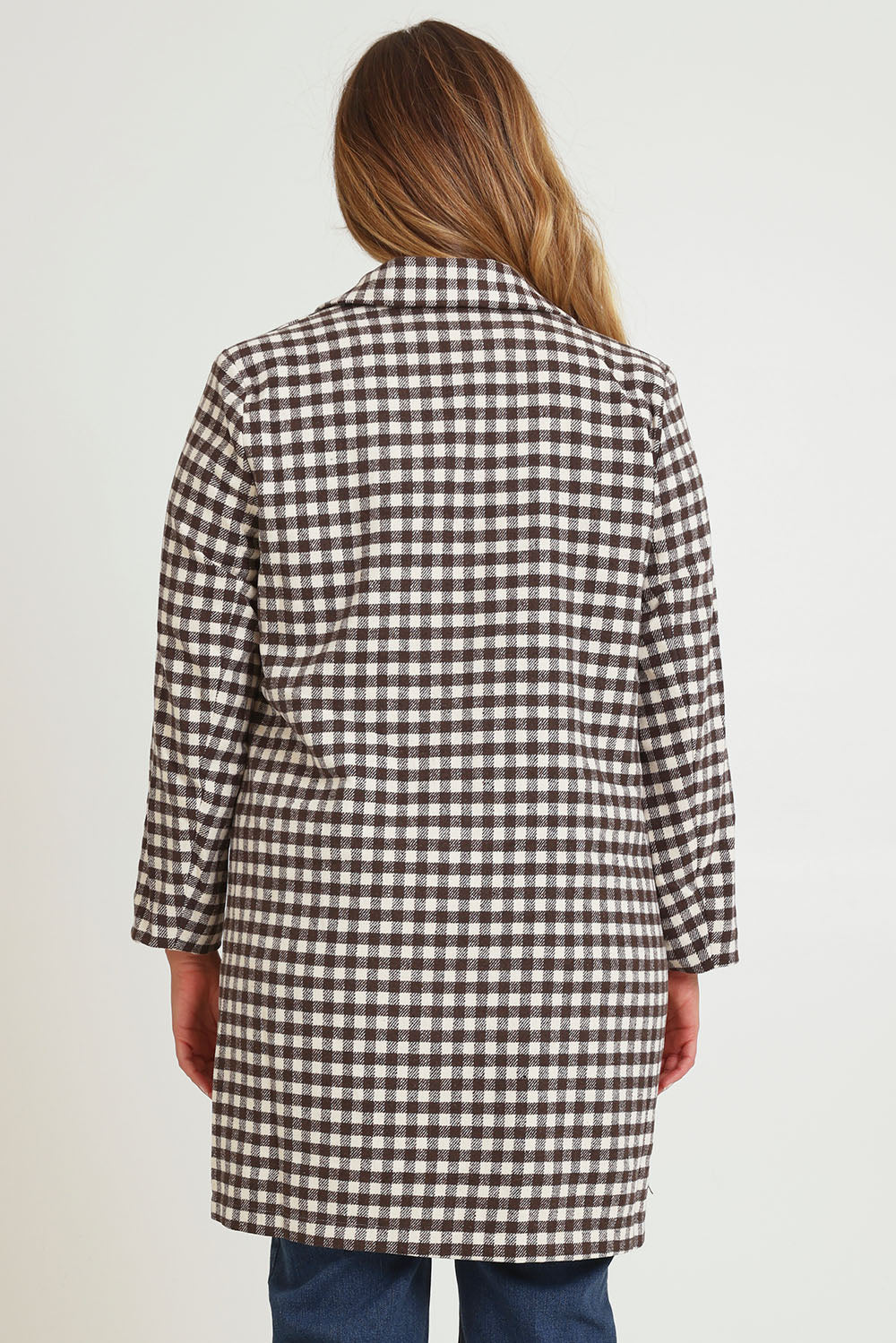 Model Chanel wearing size 16 of the Checked In Overcoat in colour Chocheck, from the back