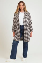 Model Chanel wearing size 16 of the Checked In Overcoat in colour Chocheck, from the front, showing the whole outfit