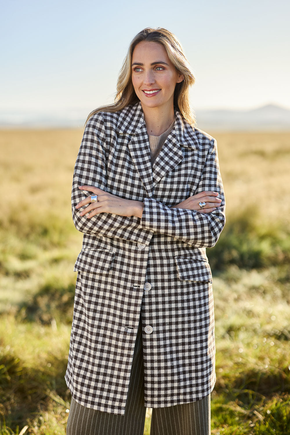 Model Tegan wearing size 10 of the Checked In Overcoat in colour Chocheck, from the front, showing the whole outfit