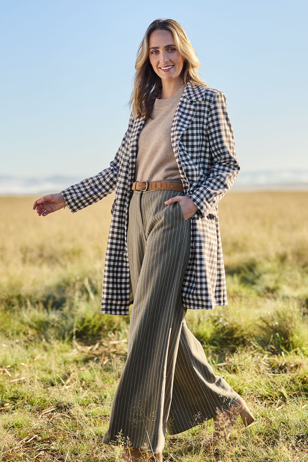 Model Tegan wearing size 10 of the Checked In Overcoat in colour Chocheck, from the front, showing the whole outfit