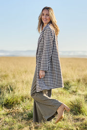 Model Tegan wearing size 10 of the Checked In Overcoat in colour Chocheck, from the front, showing the whole outfit