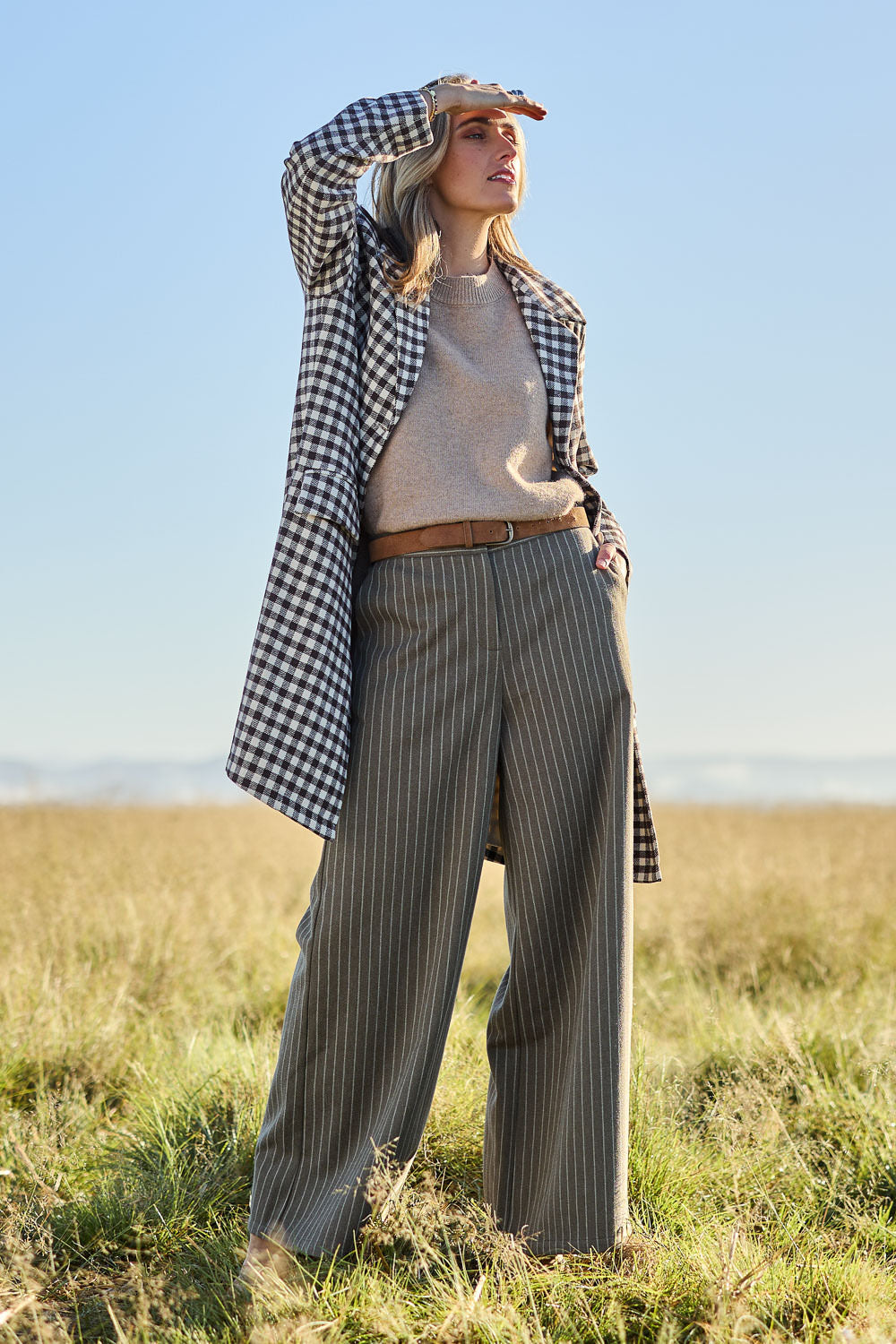 Model Tegan wearing size 10 of the Walk This Way Wide Leg Pants in colour Chocstripe, from the front, showing the whole outfit