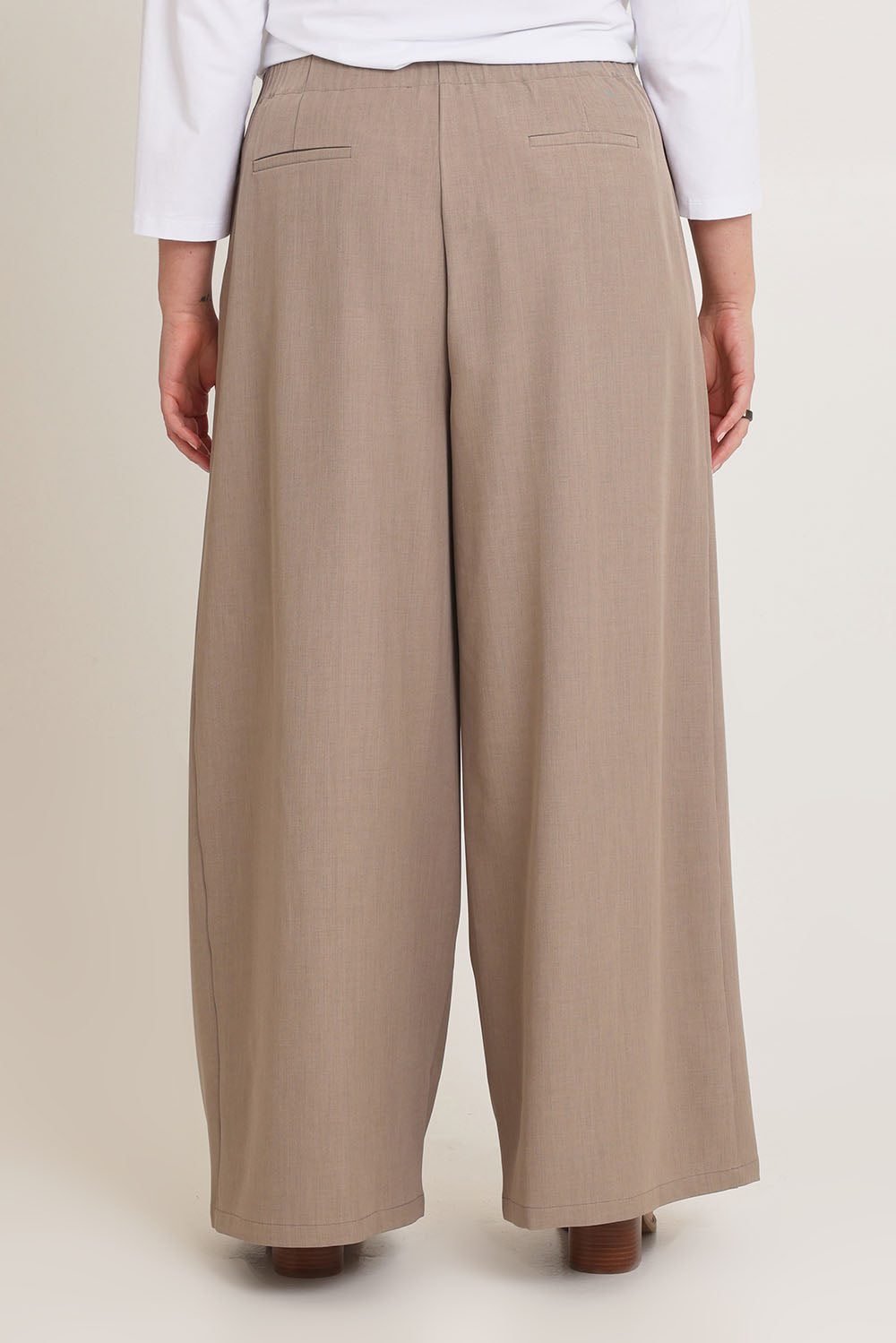 Model Chanel wearing size 16 of the Always Ready Cross Front Wide Leg Pants in colour Rock, from the back