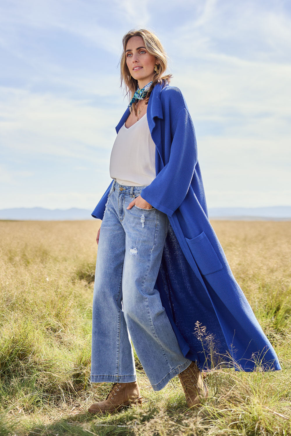 Model Tegan wearing size S of the Delight Me Long Cotton Cardi in colour Electric (Blue), from the front, showing the whole outfit