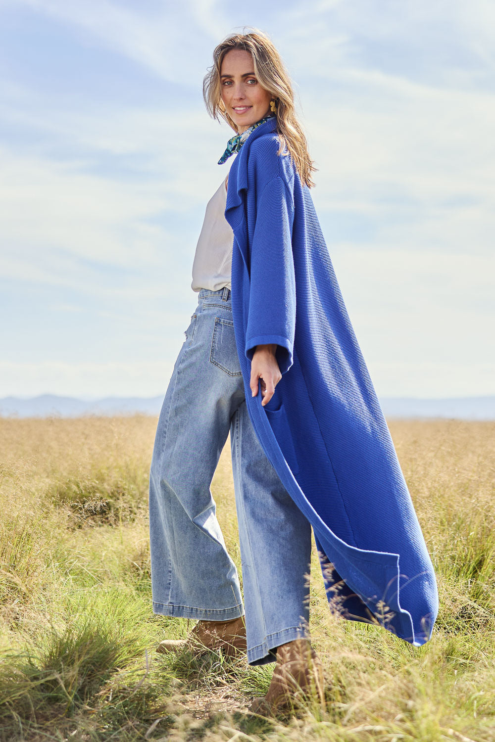 Model Tegan wearing size S of the Delight Me Long Cotton Cardi in colour Electric (Blue), from the front, showing the whole outfit