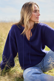Model Tegan wearing size S of the Cozy As A Cloud Balloon Sleeve Jumper in colour Royal (Blue), from the front, showing the whole outfit