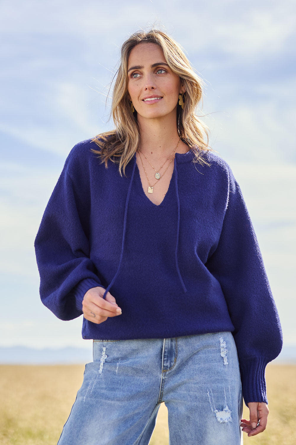 Model Tegan wearing size S of the Cozy As A Cloud Balloon Sleeve Jumper in colour Royal (Blue), from the front, showing the whole outfit