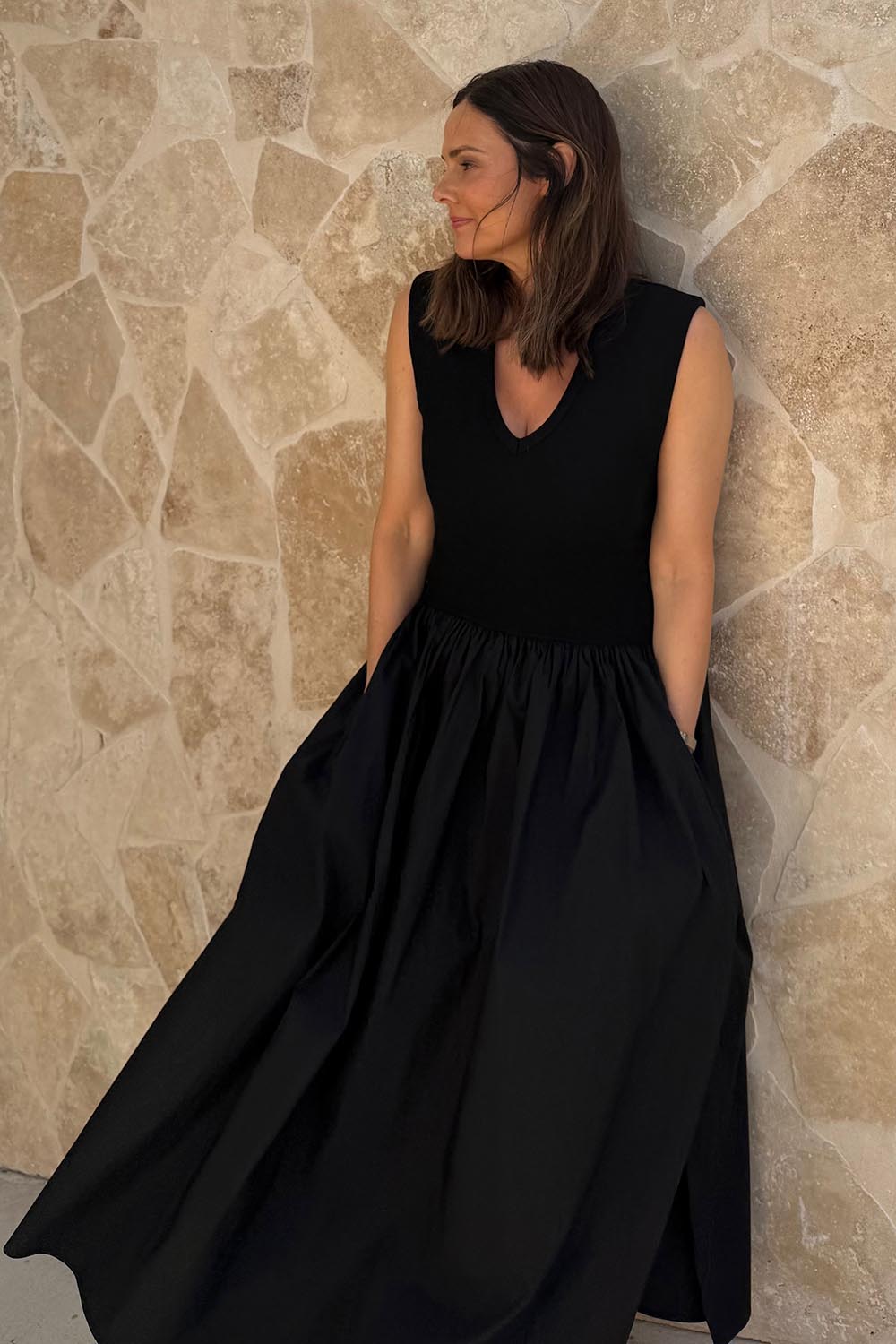 A model wearing size 10 of the Sweet Intentions V Neck Maxi Dress in colour Black (Black), from the front, showing the whole outfit