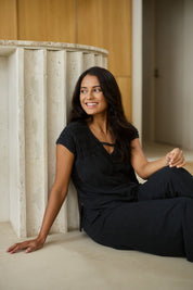 Model Tahnee wearing size 10 of the Relax Ruched Shoulder Tee in colour Washedblk (Black), from the front, showing the whole outfit
