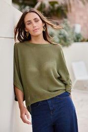 Model Tegand wearing size 10 of the Summer Ready Cotton Throw Sweater – Moss in colour Moss, in a cropped view