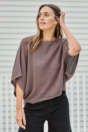 Model Tegand wearing size 10 of the Summer Ready Cotton Throw Sweater – Pecan in colour Pecan, from an angle