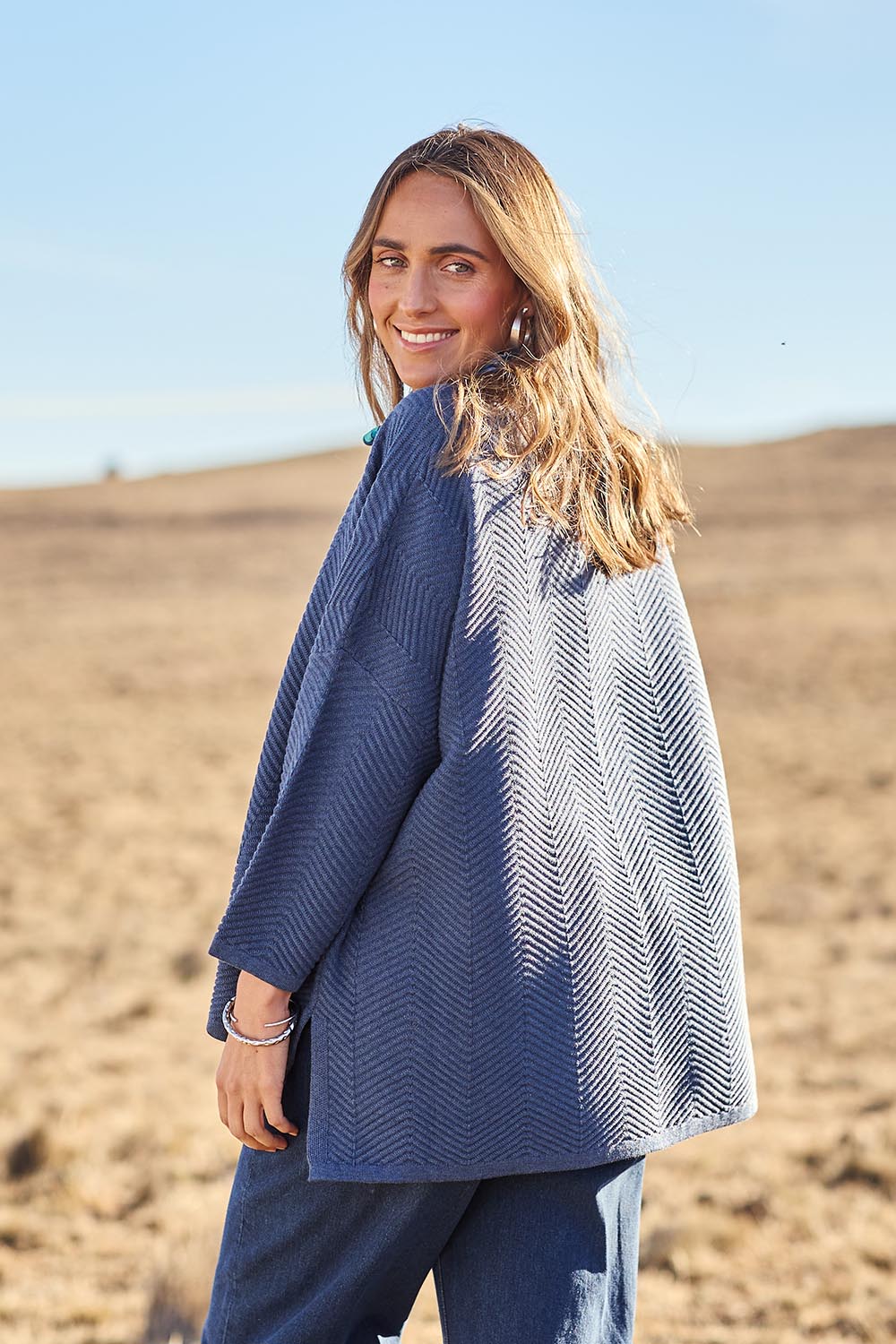 Model Tegan wearing size S of the Easy Does It Knit Top in colour Denim (Blue), from the front, showing the whole outfit