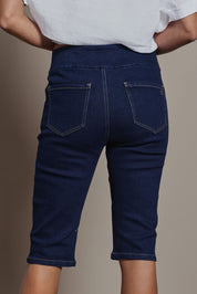 Model Amanda wearing size 10 of the Easy As Pull On Long Shorts in colour Denim (Blue), from the back