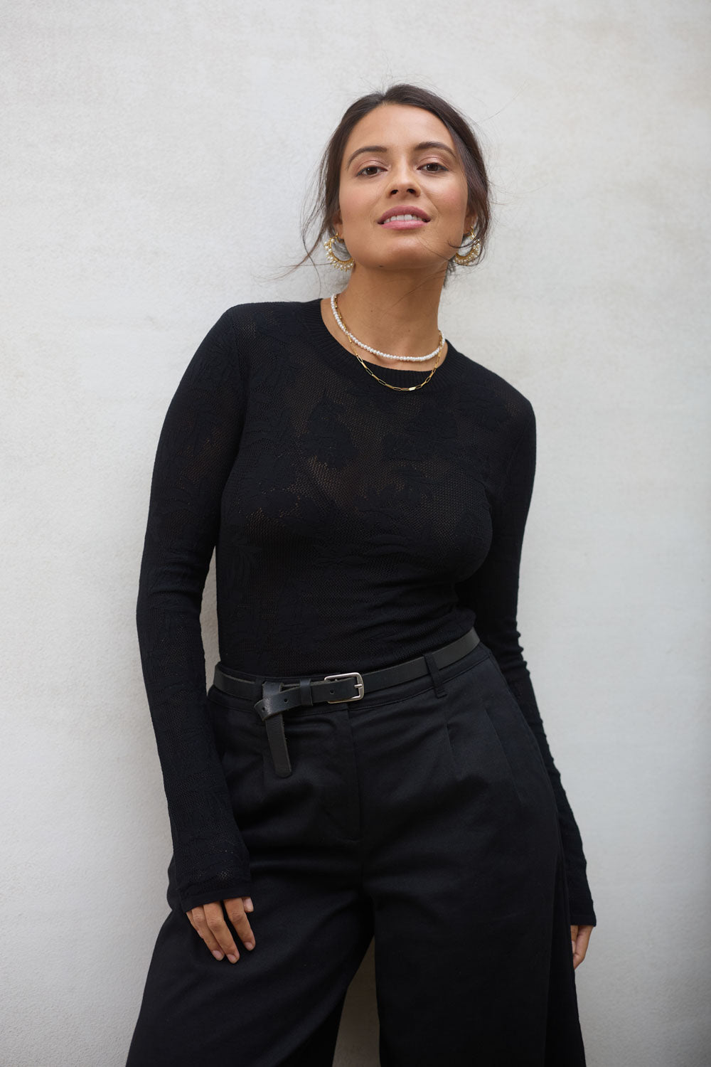 Model Tahnee wearing size S of the Love Layer Long Sleeve Knit Top in colour Black (Black), from the front, showing the whole outfit