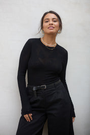 Model Tahnee wearing size S of the Love Layer Long Sleeve Knit Top in colour Black (Black), from the front, showing the whole outfit