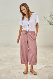 Model Tegand wearing size 10 of the Summer Daze Striped Pull On 3/4 Pant – Plum in colour Plum, from the front