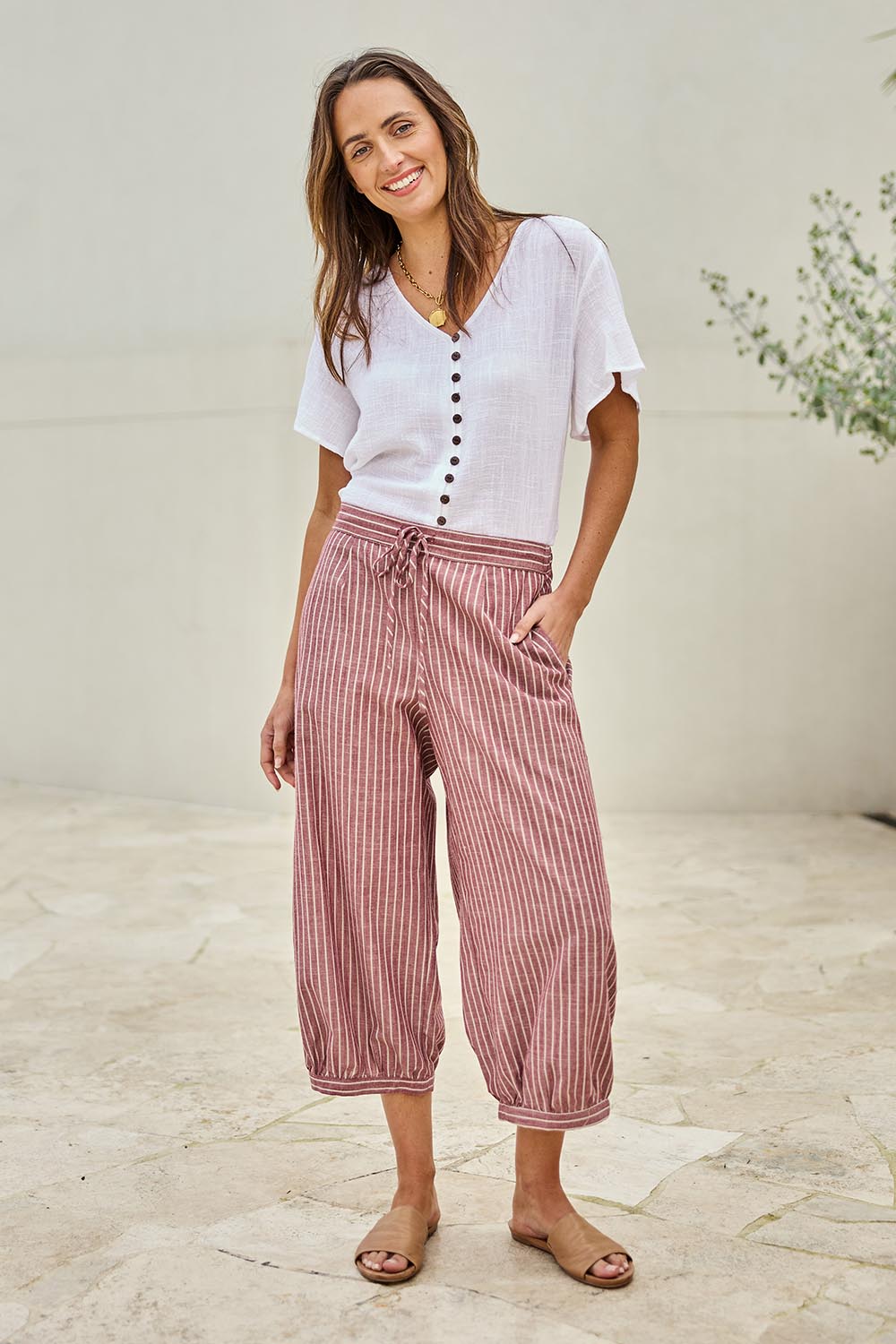 Model Tegand wearing size 10 of the Summer Daze Striped Pull On 3/4 Pant – Plum in colour Plum, from the front