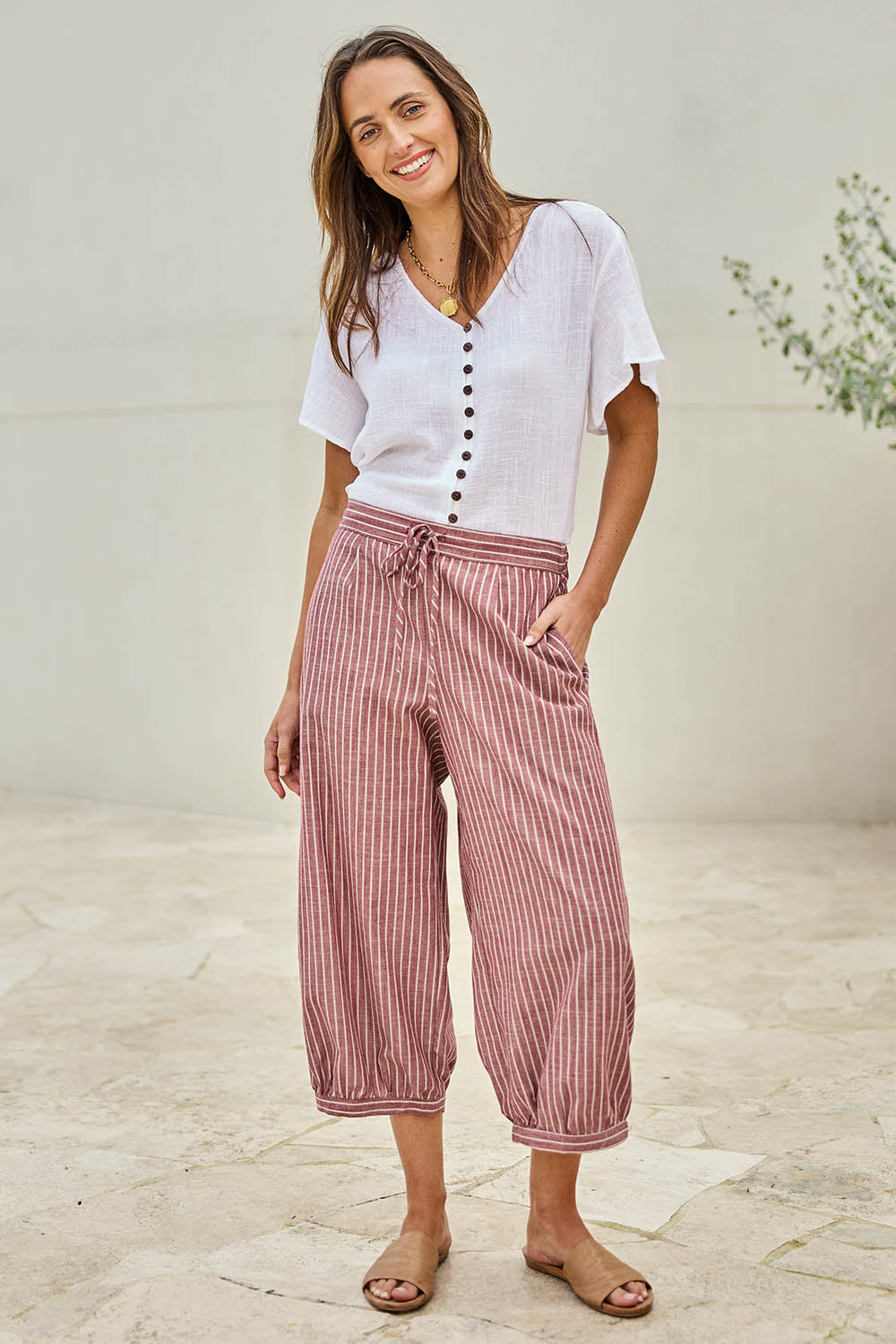Model Tegand wearing size 10 of the Summer Daze Striped Pull On 3/4 Pant – Plum in colour Plum, from the front