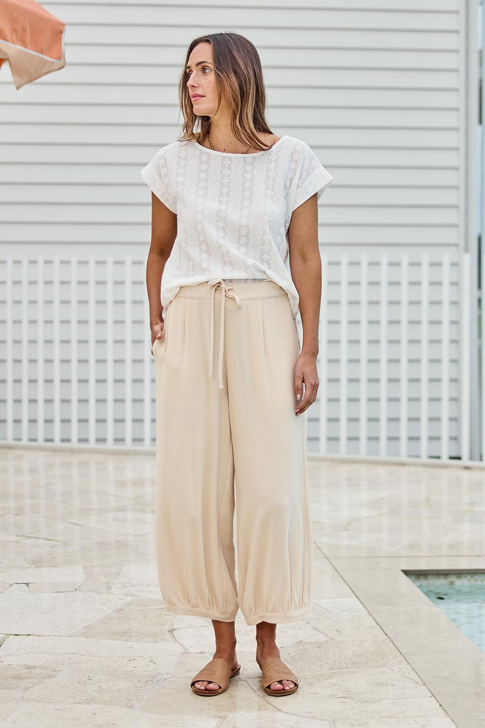 Model Tegand wearing size 10 of the Summer Daze Pull On Linen Blend Knit Pant – Sand in colour Sand, from the front