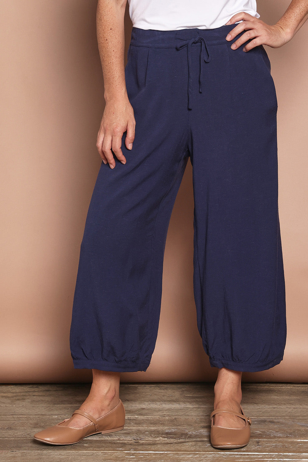 Model Katie wearing size 10 of the Summer Daze Linen Blend Pull On 3/4 Pant in colour Navy (Blue), from the front, cropped image