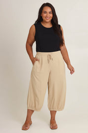 Model Ashleigh wearing size 16 of the Summer Daze Linen Blend Pull On 3/4 Pant in colour Sand, from the front, showing the whole outfit