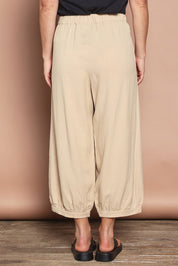 Model Katie wearing size 10 of the Summer Daze Linen Blend Pull On 3/4 Pant in colour Sand, from the back