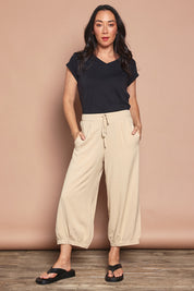Model Katie wearing size 10 of the Summer Daze Linen Blend Pull On 3/4 Pant in colour Sand, from the front, showing the whole outfit