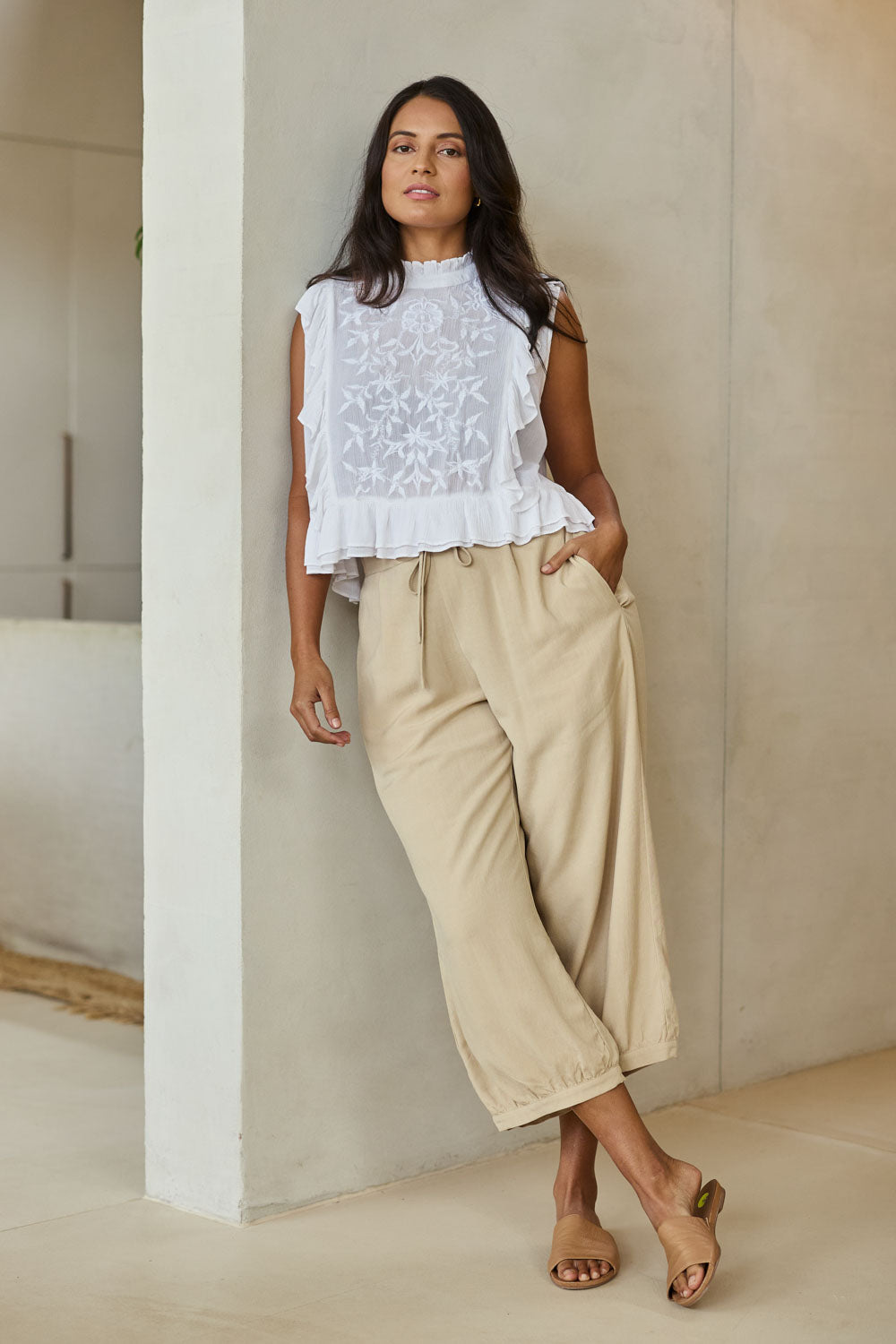 Model Tahnee wearing size 10 of the Summer Daze Linen Blend Pull On 3/4 Pant in colour Sand, from the front, showing the whole outfit