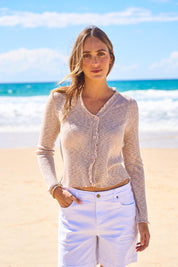 Model Tegan wearing size S of the Super Fine Summer Ruffle Cardi in colour Natmarl, from the front, showing the whole outfit