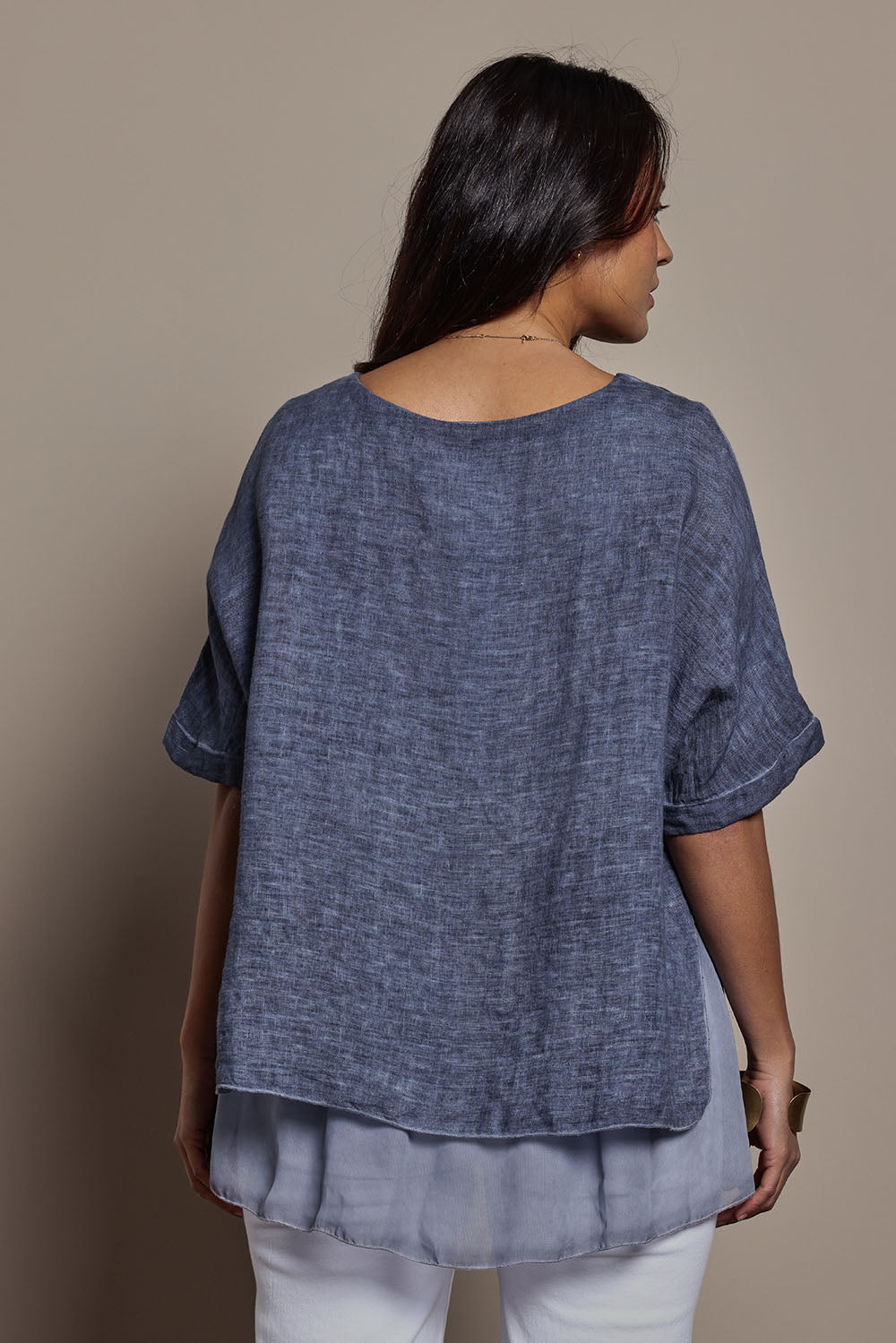 Model Tahnee wearing size 10 of the Layers Of Love Linen Overlay Top in colour Denim (Blue), from the back