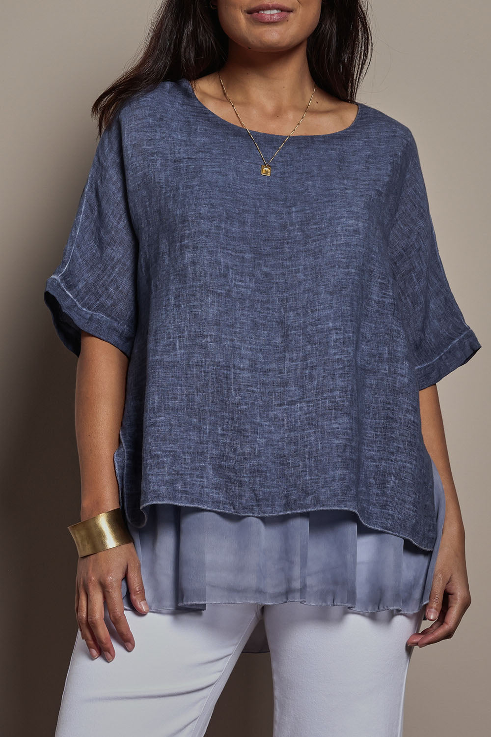 Model Tahnee wearing size 10 of the Layers Of Love Linen Overlay Top in colour Denim (Blue), from the front, cropped image
