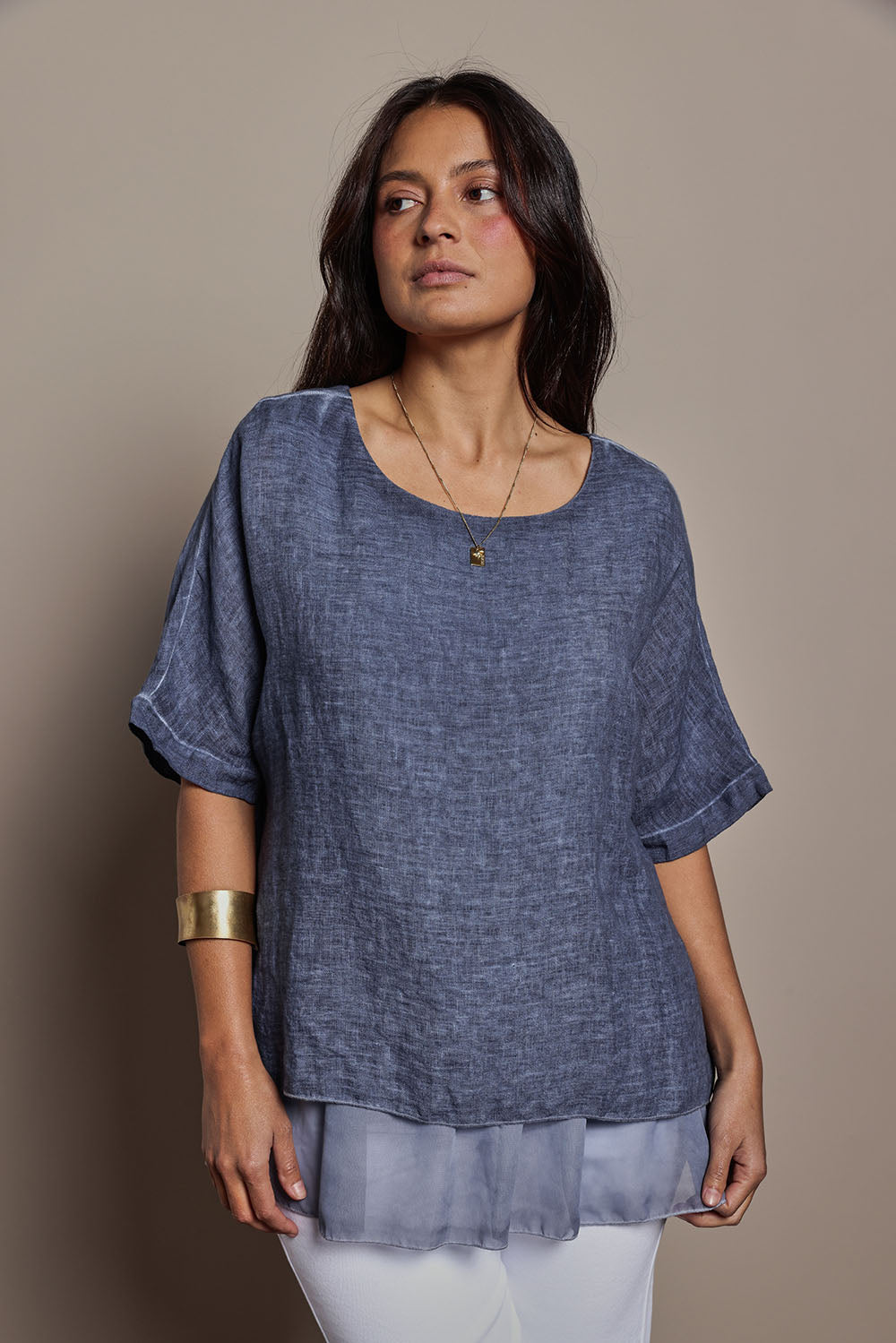 Model Tahnee wearing size 10 of the Layers Of Love Linen Overlay Top in colour Denim (Blue), from the front, cropped image