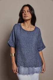Model Tahnee wearing size 10 of the Layers Of Love Linen Overlay Top in colour Denim (Blue), from the front, cropped image