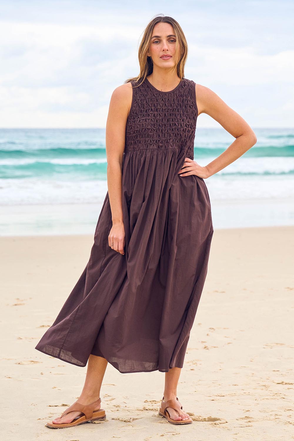 Model Tegan wearing size 10 of the Summer Breeze Smocked Cotton Dress in colour Chocolate, from the front, showing the whole outfit