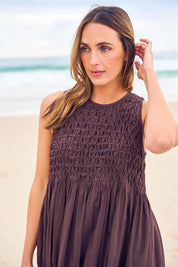 Model Tegan wearing size 10 of the Summer Breeze Smocked Cotton Dress in colour Chocolate, from the front, showing the whole outfit