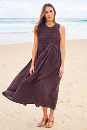 Model Tegan wearing size 10 of the Summer Breeze Smocked Cotton Dress in colour Chocolate, from the front, showing the whole outfit