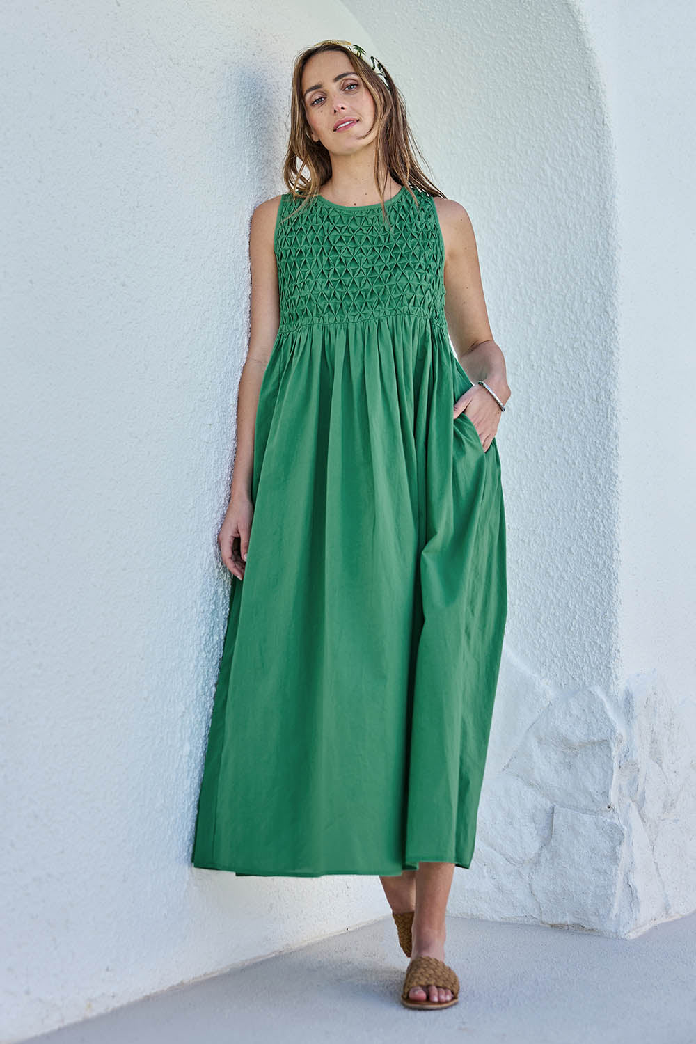 Model Tegand wearing size 10 of the Summer Breeze Smocked Cotton Dress – Green in colour Green, from the front
