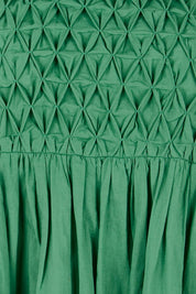 Product shot of the Summer Breeze Smocked Cotton Dress – Green in colour Green, showing detail