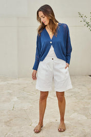 Model Tegand wearing size 10 of the Summer Haze Cardigan – Denim in colour Denim, from the front