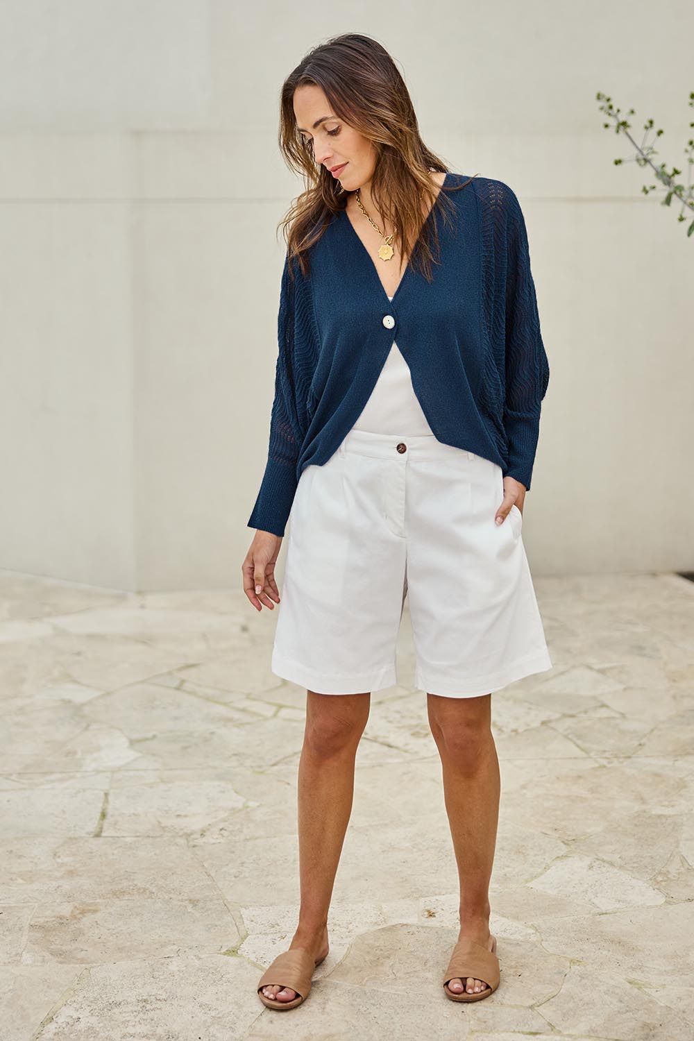 Model Tegand wearing size 10 of the Summer Haze Cardigan – Denim in colour Denim, from the front