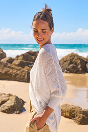 Model Tegan wearing size S of the Summer Haze Cardigan in colour White, from the front, showing the whole outfit