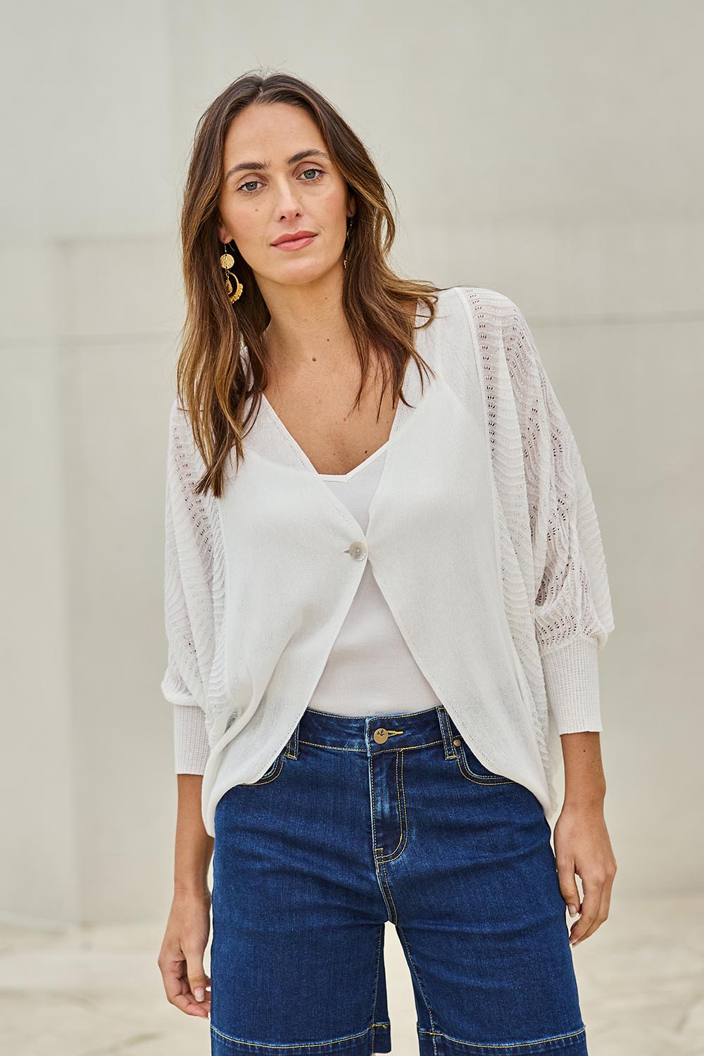Model Tegand wearing size 10 of the Summer Haze Cardigan – White in colour White, in a cropped view
