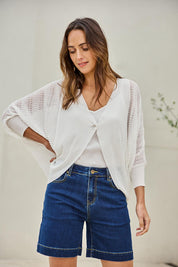 Model Tegand wearing size 10 of the Summer Haze Cardigan – White in colour White, in a cropped view