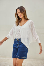Model Tegand wearing size 10 of the Summer Haze Cardigan – White in colour White, in a cropped view
