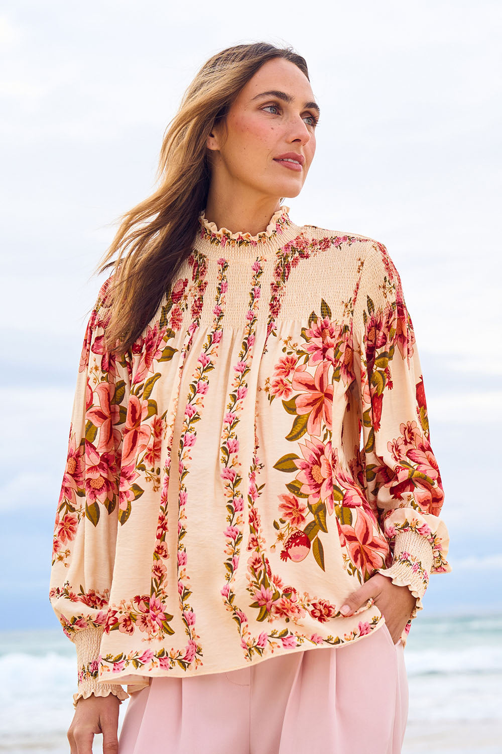 Model Tegan wearing size 10 of the Floral Affair Blouse in colour Creamfleur (Pink), from the front, showing the whole outfit