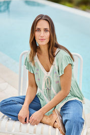 Model Tegand wearing size 10 of the Morning Sunlight Embroidered Blouse – Pistachio in colour Pistachio, in a cropped view