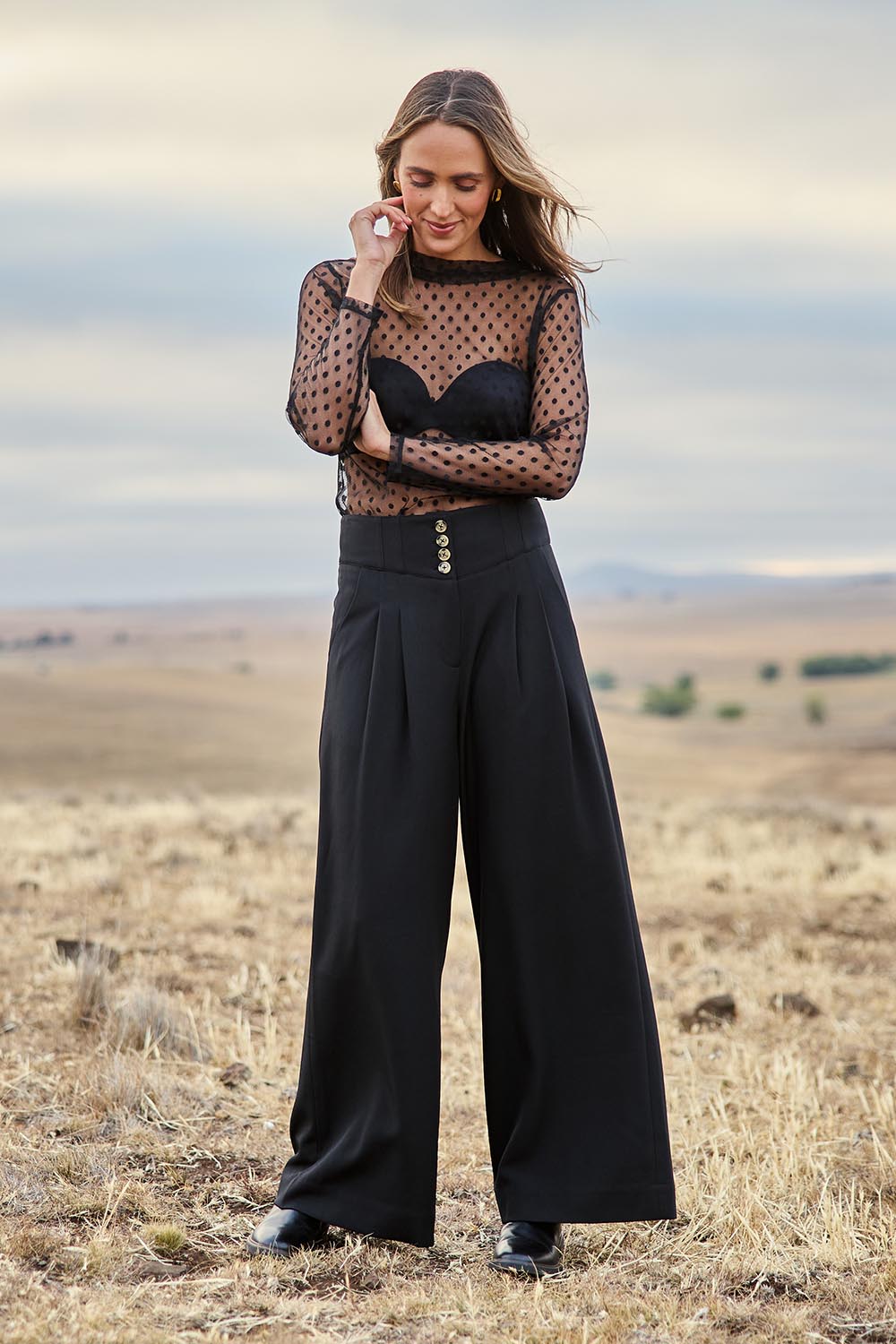 Model Tegan wearing size 10 of the Layer Me Up Lace Mesh Long Sleeve Top in colour Black (Black), from the front, showing the whole outfit