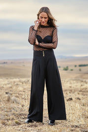 Model Tegan wearing size 10 of the Layer Me Up Lace Mesh Long Sleeve Top in colour Black (Black), from the front, showing the whole outfit
